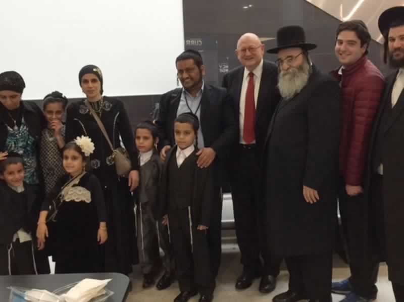 With a family of refugees and former U.S. Envoy to Monitor and Combat Anti-Semitism, 
                            Ira Forman, at JFK Airport